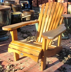 Classic Adirondack Adirondack chair, surely created for the enjoyment of a a garden