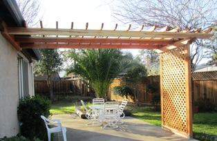 The completed trellis for the wisteria awaits a fountain and hanging plants