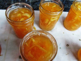 These jars are filled with hot fruit mixture, ready for lids and canning