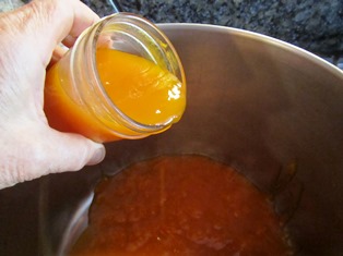 Emptying jam back into a cooking pot is the first step in repairing a batch that didn't jell