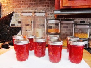Jars of blood orange marmalade in a festive red currant color