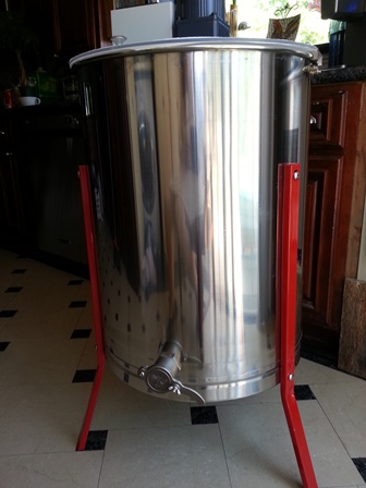 This electric honey extractor holds four frames; honey is spun out through centrifugal force
