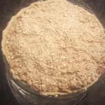 Unbaked, the crumb topping has been added in place of a top crust